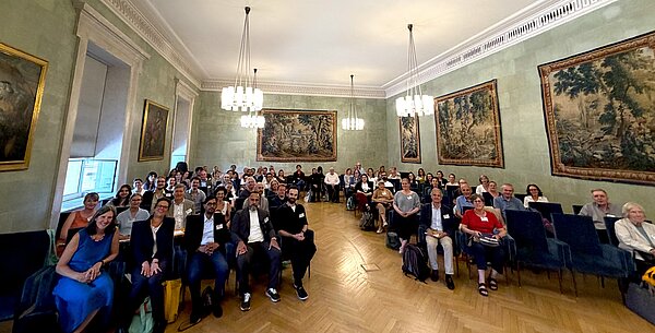 A photo of the audience sitting in the conference room.
