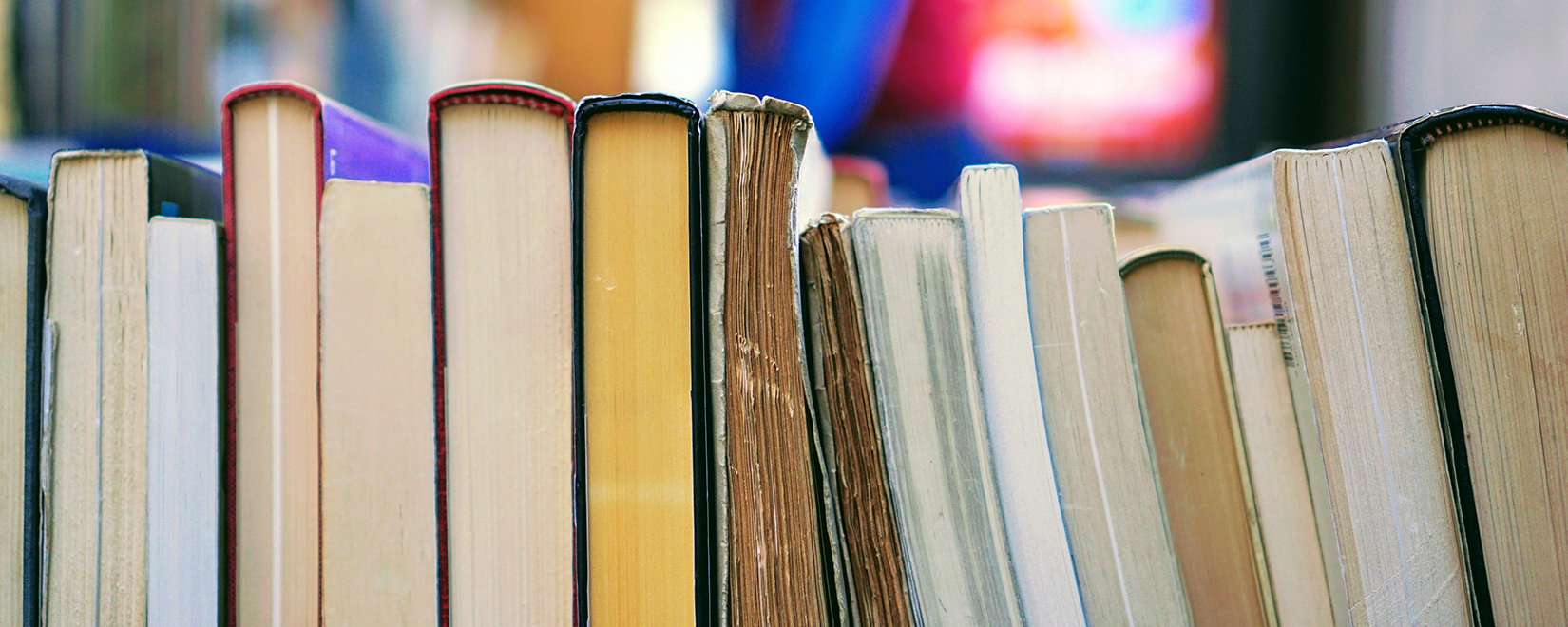 A row of books lying on the side, so you see the bottom.
